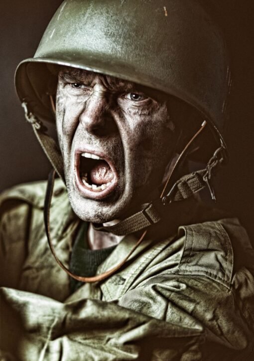 Close-up of a soldier in camouflage shouting during a military action scene.