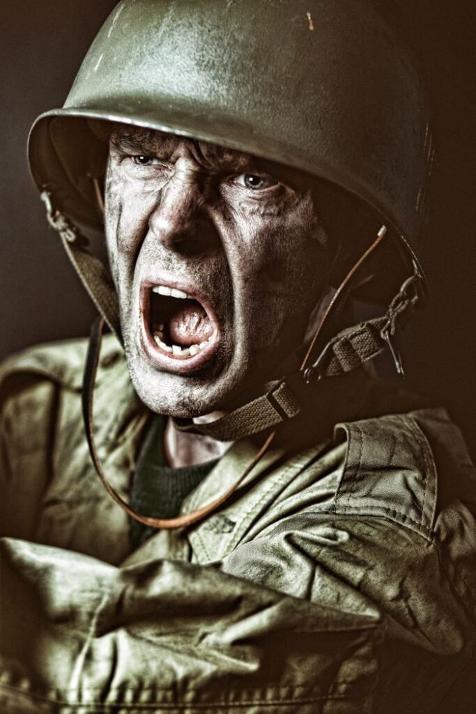 Close-up of a soldier in camouflage shouting during a military action scene.