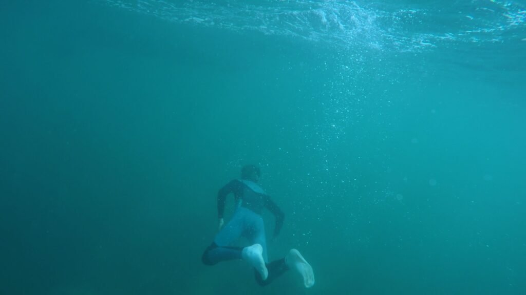 Explore underwater scenes of a snorkeler in a vibrant turquoise ocean, capturing the thrill of diving.