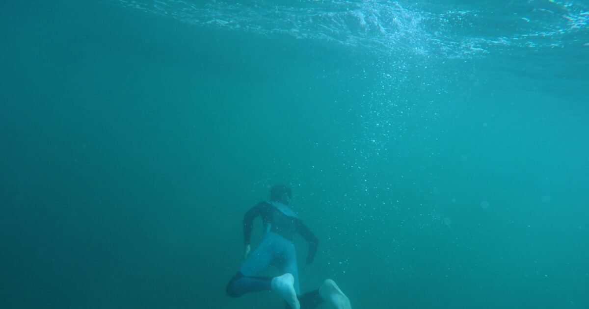 Explore underwater scenes of a snorkeler in a vibrant turquoise ocean, capturing the thrill of diving.