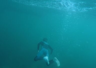 Explore underwater scenes of a snorkeler in a vibrant turquoise ocean, capturing the thrill of diving.