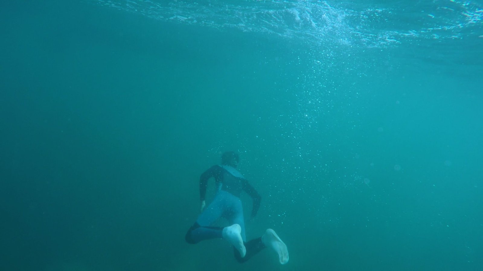 Explore underwater scenes of a snorkeler in a vibrant turquoise ocean, capturing the thrill of diving.