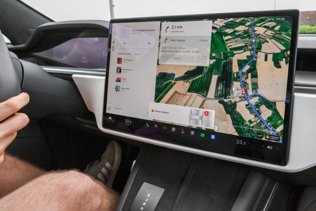 Inside view of a car with a large navigation screen and detailed digital map.