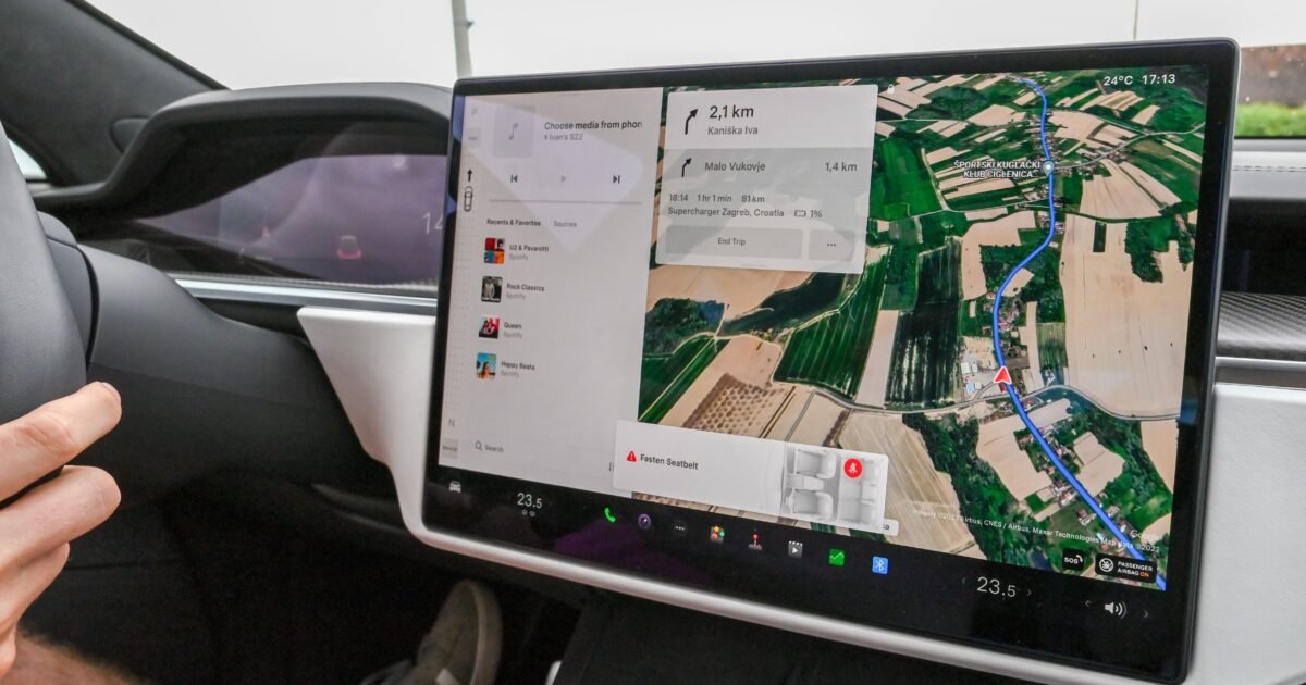 Inside view of a car with a large navigation screen and detailed digital map.