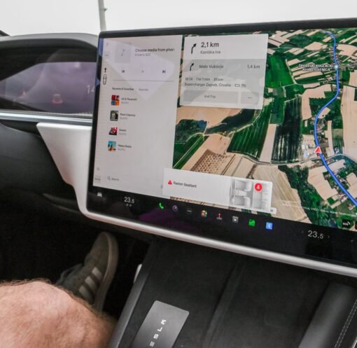 Inside view of a car with a large navigation screen and detailed digital map.