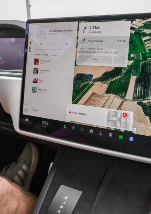 Inside view of a car with a large navigation screen and detailed digital map.
