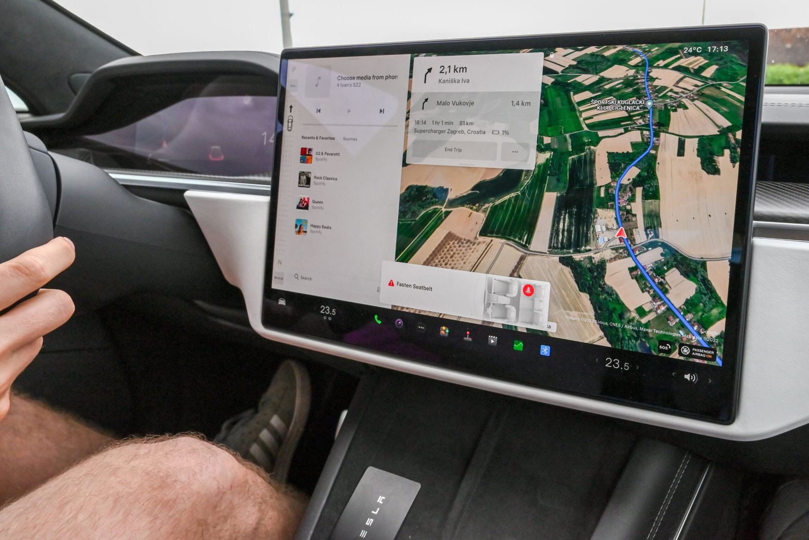 Inside view of a car with a large navigation screen and detailed digital map.