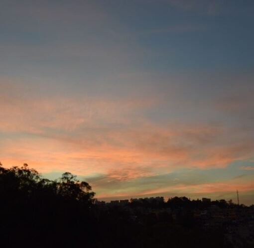 Beautiful sunset over Ciudad de México showcasing a colorful sky and urban silhouette.