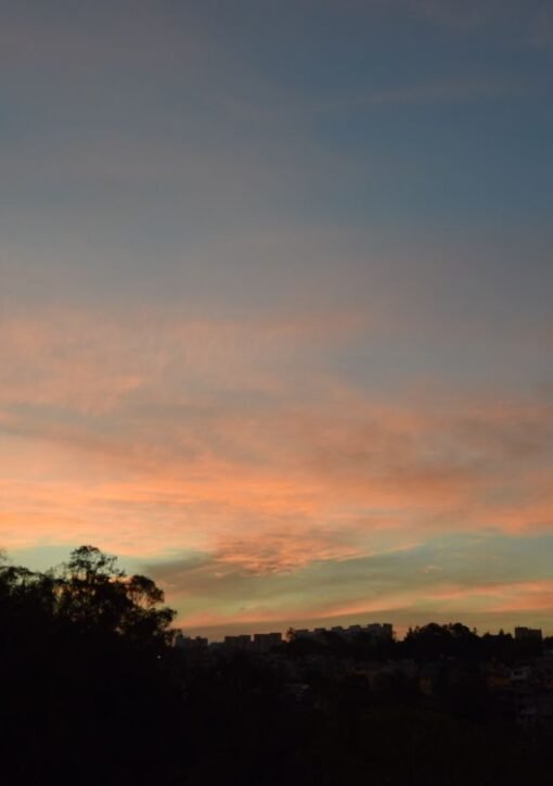 Beautiful sunset over Ciudad de México showcasing a colorful sky and urban silhouette.