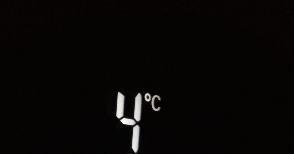 Close-up of electronic screen showing 4°C and -20°C in white digits