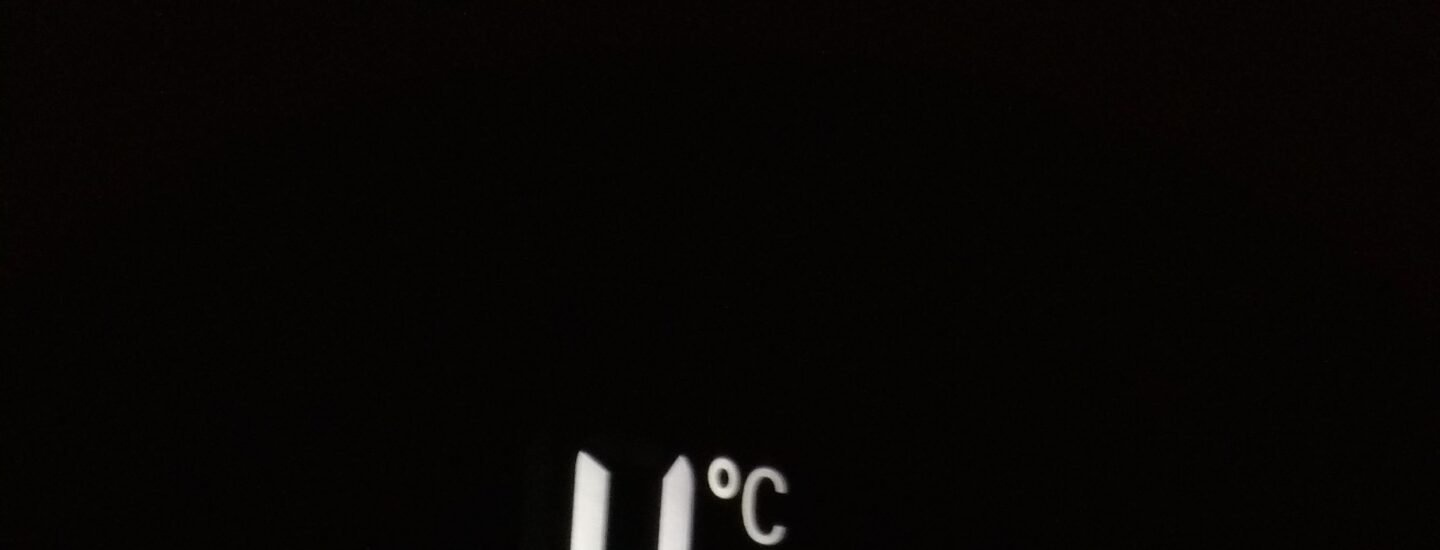 Close-up of electronic screen showing 4°C and -20°C in white digits
