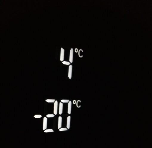 Close-up of electronic screen showing 4°C and -20°C in white digits
