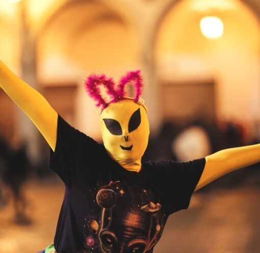 Person in alien costume with quirky ears during a lively Arequipa celebration.