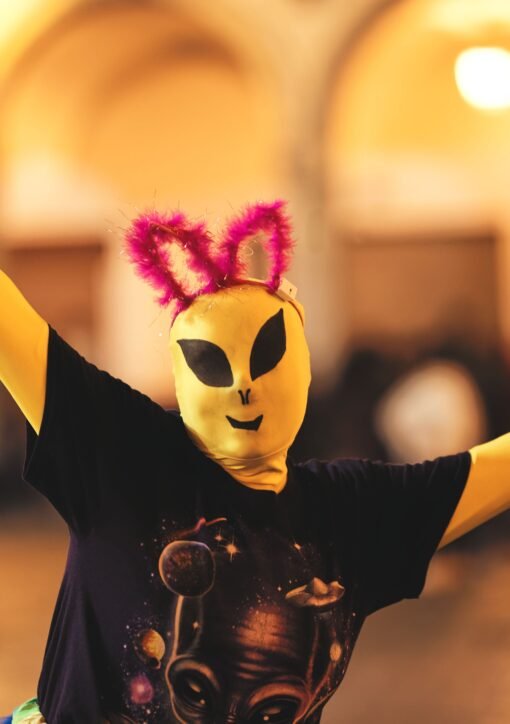 Person in alien costume with quirky ears during a lively Arequipa celebration.