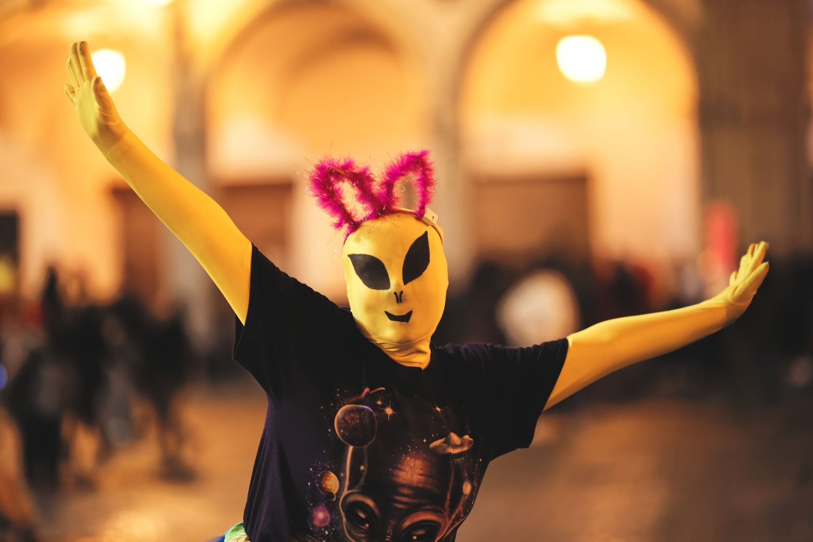 Person in alien costume with quirky ears during a lively Arequipa celebration.