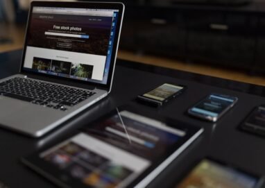 A contemporary workspace showcasing a laptop, tablet, and smartphones, ideal for tech and freelance use.