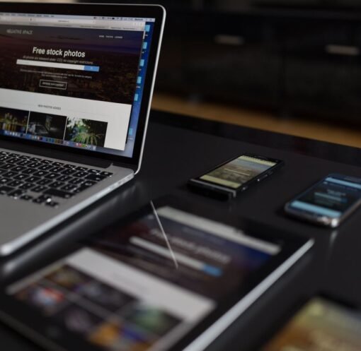 A contemporary workspace showcasing a laptop, tablet, and smartphones, ideal for tech and freelance use.
