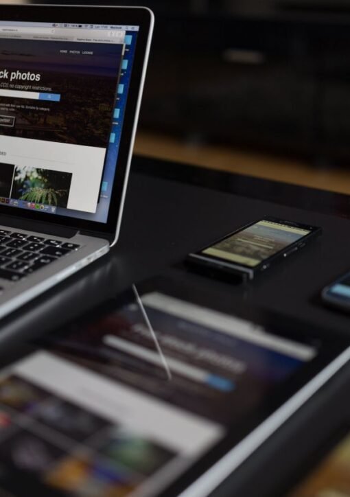 A contemporary workspace showcasing a laptop, tablet, and smartphones, ideal for tech and freelance use.