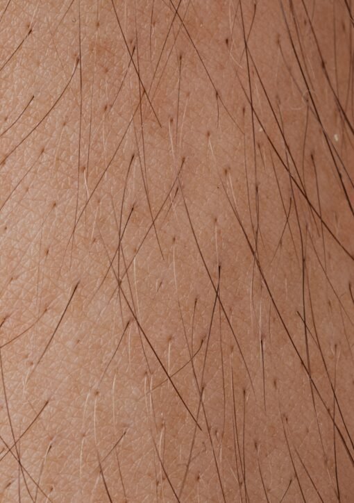 Detailed macro image showing human skin texture and hair follicles.
