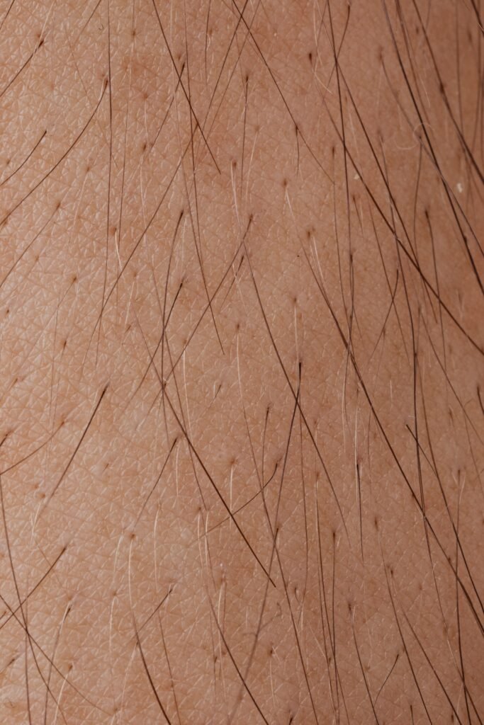 Detailed macro image showing human skin texture and hair follicles.