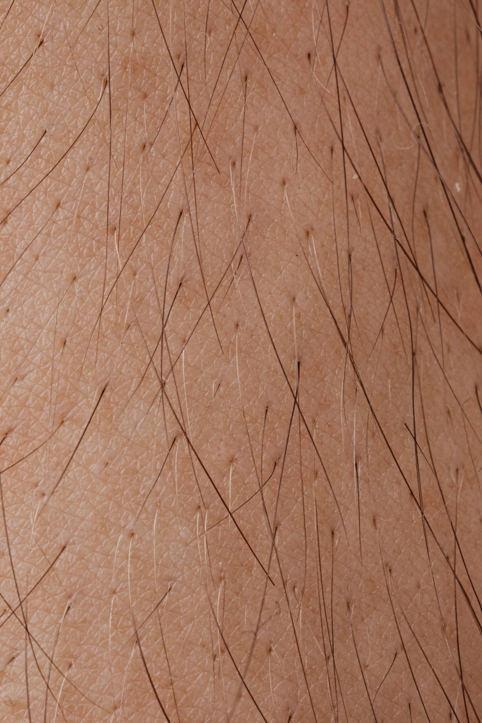 Detailed macro image showing human skin texture and hair follicles.