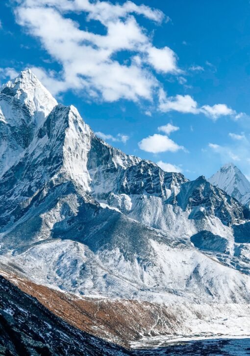 A stunning view of a snow-capped mountain peak under a clear blue sky, showcasing nature's beauty.