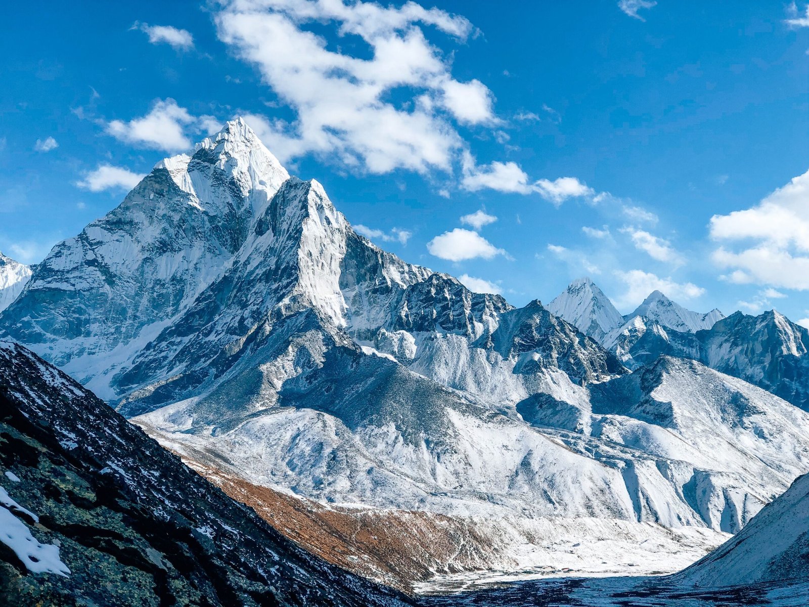 A stunning view of a snow-capped mountain peak under a clear blue sky, showcasing nature's beauty.