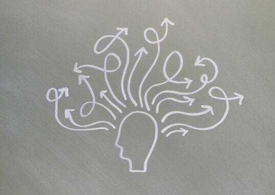 Conceptual chalk drawing illustrating mental health challenges with arrows representing thoughts.
