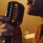 Dynamic close-up of a female singer holding a vintage microphone during a live performance.