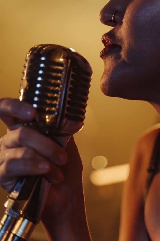 Dynamic close-up of a female singer holding a vintage microphone during a live performance.