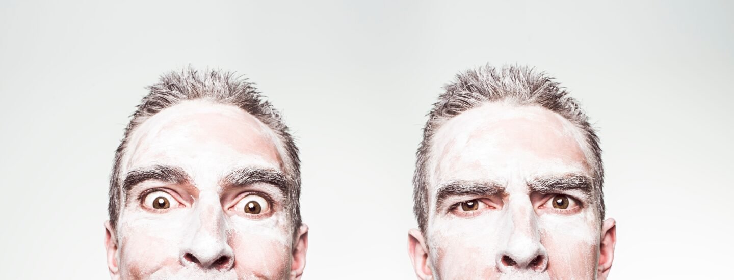 A whimsical portrait showing dual expressions of a man with a painted face.