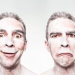 A whimsical portrait showing dual expressions of a man with a painted face.