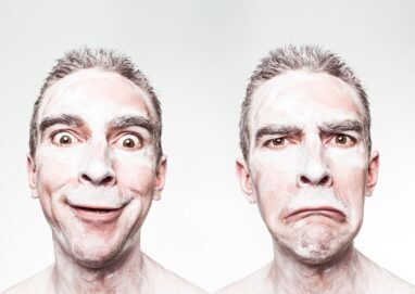 A whimsical portrait showing dual expressions of a man with a painted face.