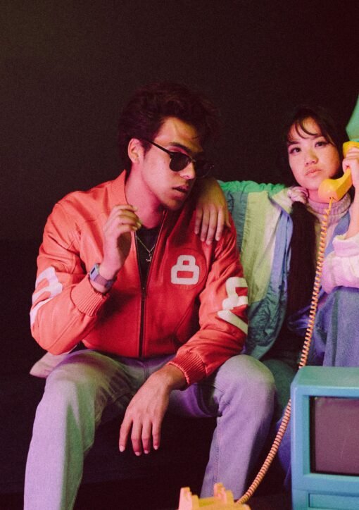 Young models in retro attire with vintage props and warm, moody lighting.