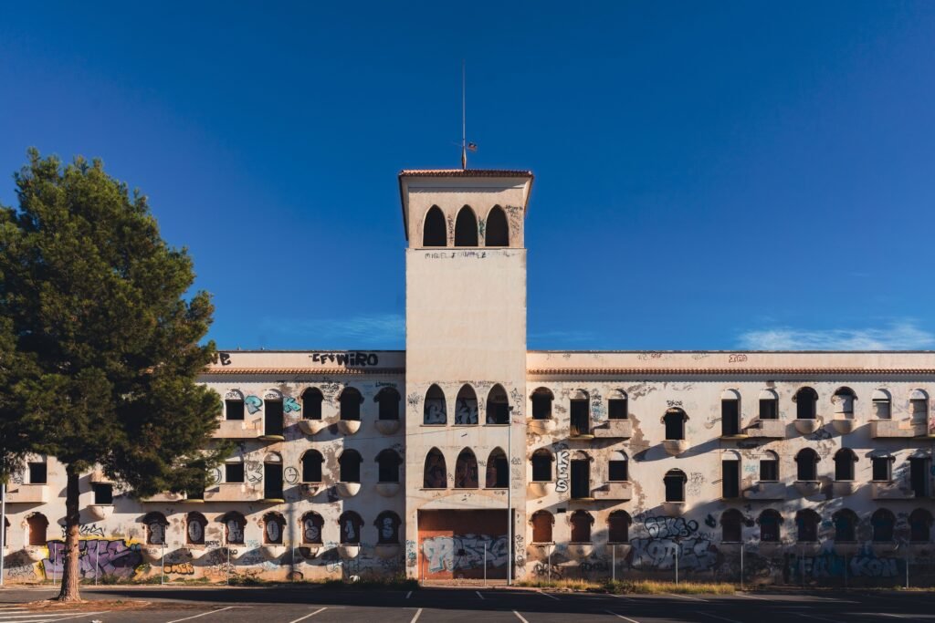 An abandoned building with graffiti under a clear blue sky in San Javier, Spain.