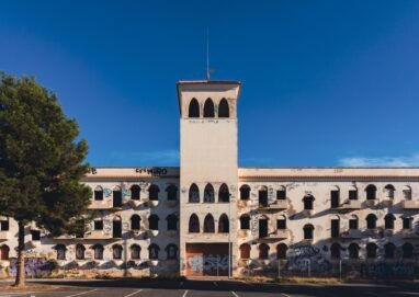 An abandoned building with graffiti under a clear blue sky in San Javier, Spain.