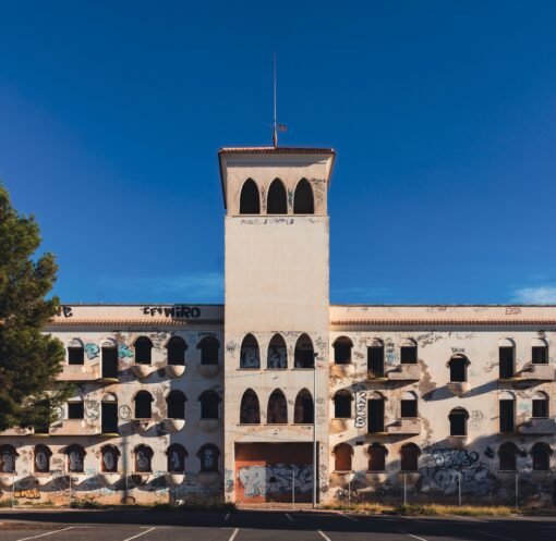 An abandoned building with graffiti under a clear blue sky in San Javier, Spain.
