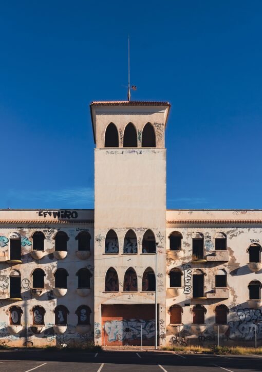 An abandoned building with graffiti under a clear blue sky in San Javier, Spain.