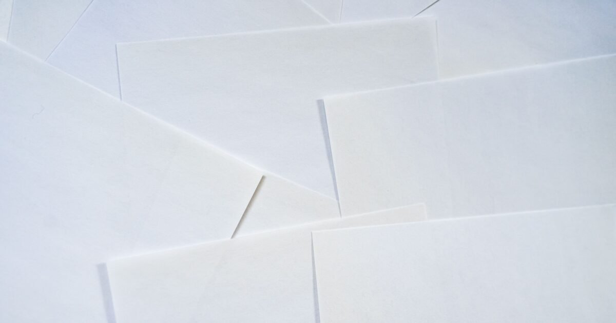 Abstract image featuring overlapping sheets of white paper creating geometric textures.