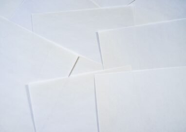 Abstract image featuring overlapping sheets of white paper creating geometric textures.