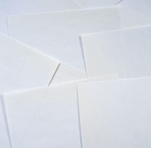 Abstract image featuring overlapping sheets of white paper creating geometric textures.