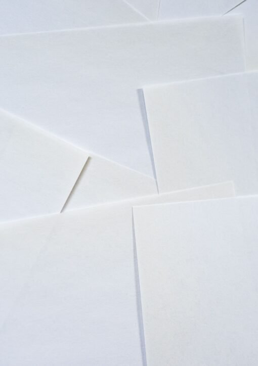 Abstract image featuring overlapping sheets of white paper creating geometric textures.