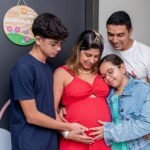 Joyful family gathering, embracing new beginnings with a baby on the way.