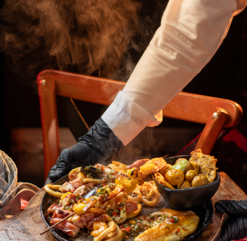 A delectable seafood platter featuring various delicacies served hot in a cozy restaurant setting.