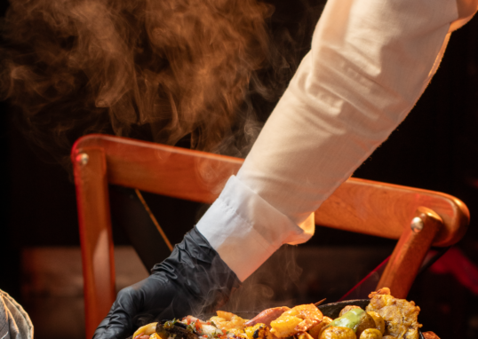 A delectable seafood platter featuring various delicacies served hot in a cozy restaurant setting.