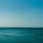 Calm blue waters of the Mediterranean Sea with a clear sky, captured near the Balearic Islands, Spain.