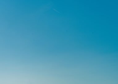 Calm blue waters of the Mediterranean Sea with a clear sky, captured near the Balearic Islands, Spain.