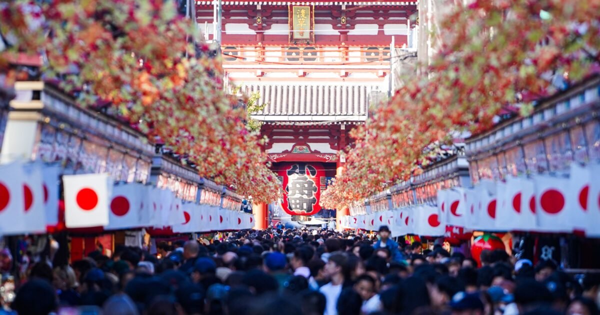 Vibrant crowd at Sensō-ji Temple in Asakusa, Tokyo, during a festive day.
