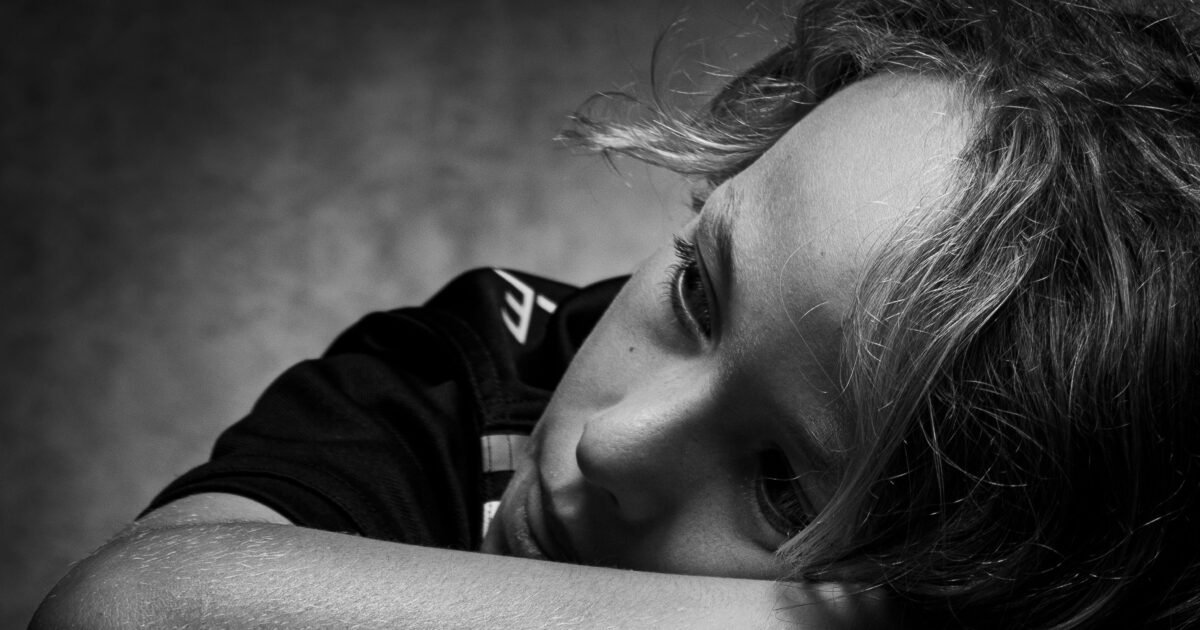 Expressive black and white portrait of a child deep in thought and contemplation.