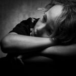 Expressive black and white portrait of a child deep in thought and contemplation.